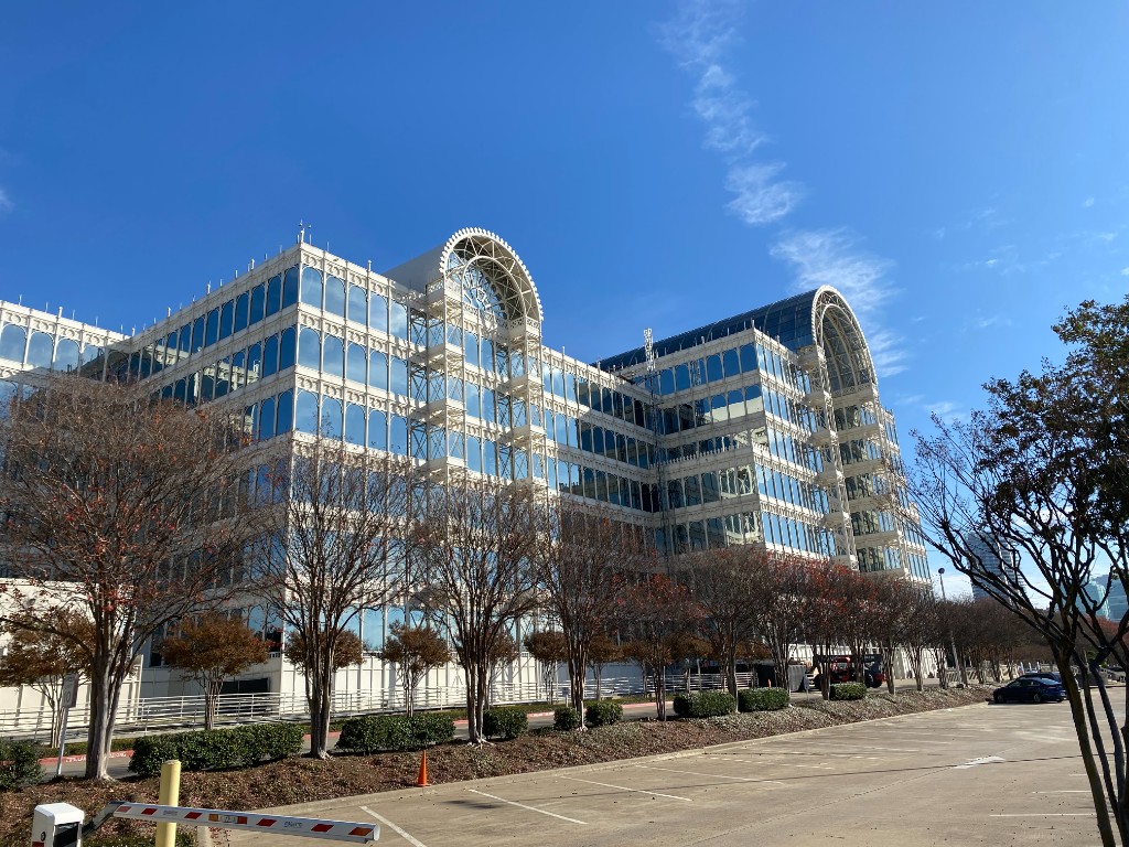 The iconic Infomart building in Dallas, Texas - a distinctive glass and white steel structure housing ServerPoint's data center
